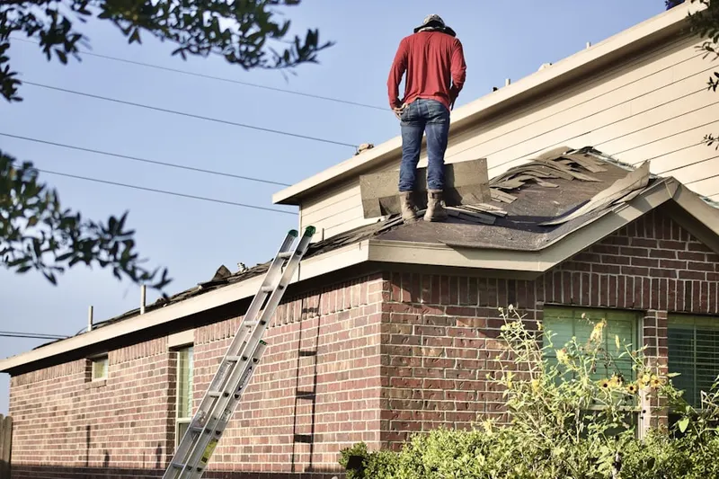 Professional roofer working on a residential roof in Sound View